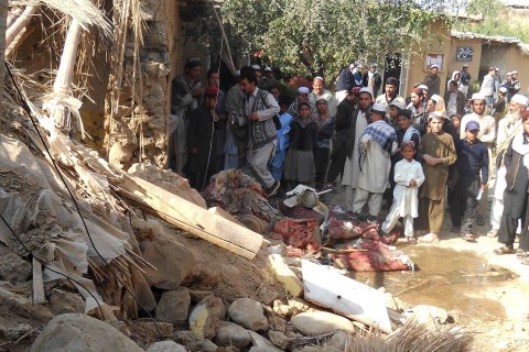 Students gather at the site of a suspected U.S. drone strike on an Islamic seminary in Hangu district