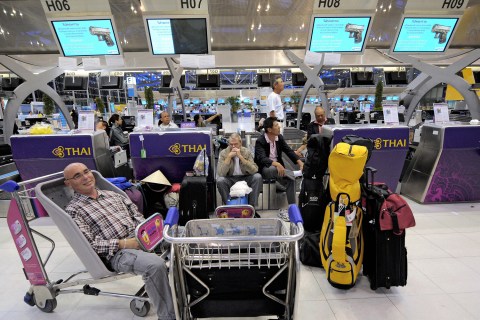 Foreign passengers sit waiting at the ch