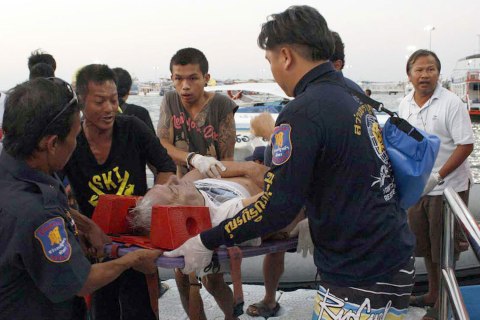 Thai rescuers carry an injured tourist