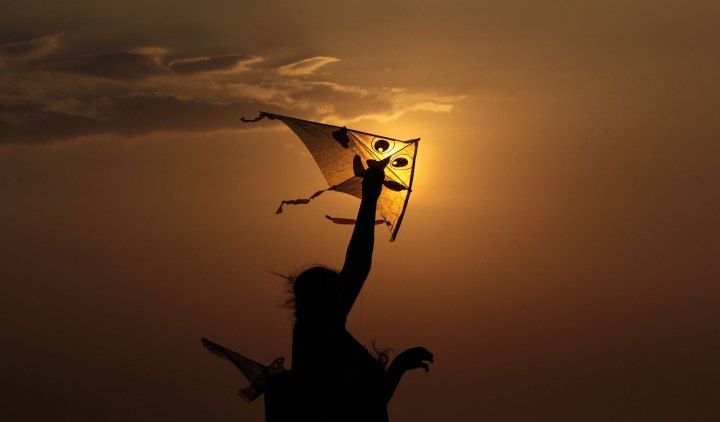 A woman holds a kite at Galle Face Green, Colombo, Srilanka on Dec. 31, 2013.