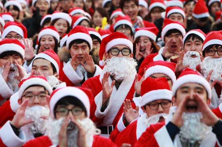 Volunteers dressed in Santa Claus costumes participate in the Christmas event for charity in Seoul, on Dec. 24, 2013.