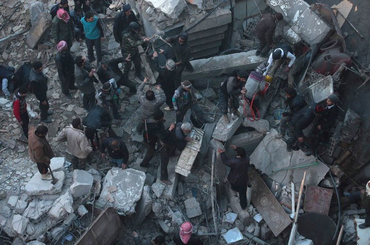 Men search for survivors from under rubble at a site hit by what activists say was an airstrike by forces loyal to Syrian President Bashar al-Assad in the Duma neighbourhood of Damascus
