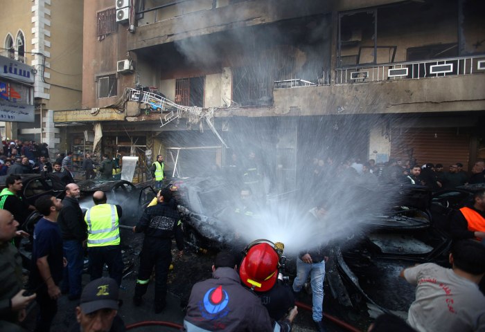 Firefighters extinguish a fire from a building at the site of an explosion in the Haret Hreik area, in the southern suburbs of the Lebanese capital Beirut