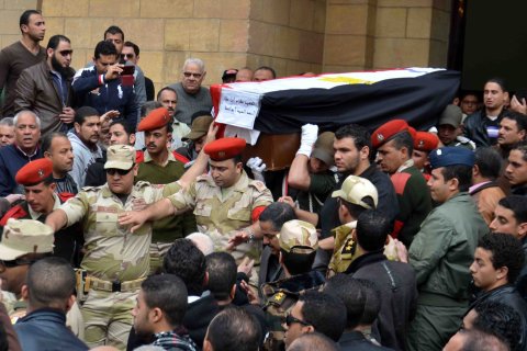 Relatives and army soldiers carry the coffin of Egyptian pilot Ahmed Abul Atta, who was killed in an army helicopter crash in Sinai Peninsula a day earlier, during the funeral procession in Port Said, Egypt, on Jan. 26, 2014.