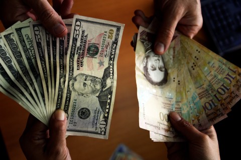 U.S. dollars and Venezuelan Bolivares in Caracas on July 16, 2013.
