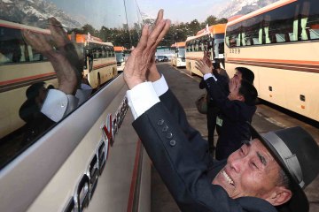 North Korean Park Un Hwa waves to his South Korean brother Park Un-hyung, 93, after their three-day temporary family reunion at the Mount Kumgang resort in North Korea, Feb. 22, 2014.