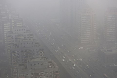 Cars drive on the Three Ring Road amid the heavy haze in Beijing
