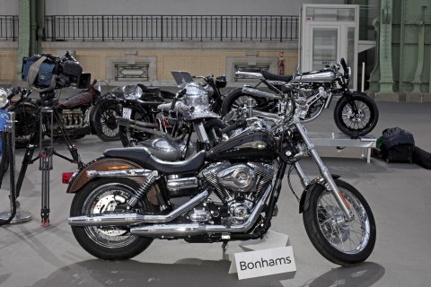 The 2013 Harley Davidson Super Glide Custom A 1,585cc Harley-Davidson Dyna Super Glide, donated to Pope Francis last year and signed by him on its tank, is displayed ahead of Bonham's sale of vintage and classic cars, at the Grand Palais in Paris, Wednesday, Feb. 5, 2014.