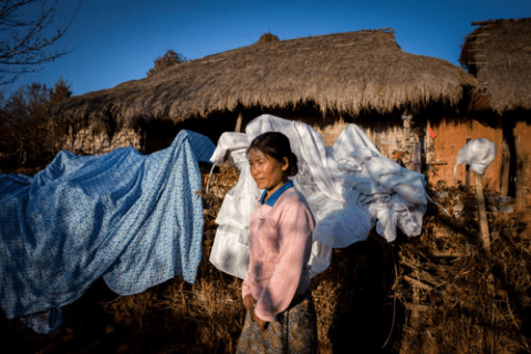 Galau Dau Yang, 35, stands outside her home in the northern Shan State village of Kut Khaing.