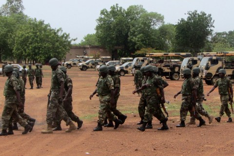 Soldiers from Lagos, part of an expected 1,000 reinforcements sent to Adamawa state to fight Boko Haram Islamists, walk near trucks as they arrive with the 23rd Armoured Brigade in Yola