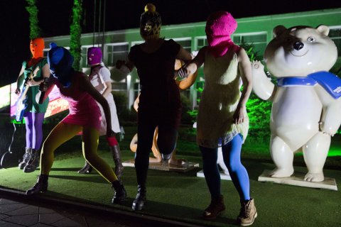 Members of Russian punk group Pussy Riot, Nadezhda Tolokonnikova (left) and Maria Alyokhina (right) perform in front of Sochi 2014 Winter Olympic games mascots as they record a video in the Adler district of Sochi, on Feb. 18, 2014.