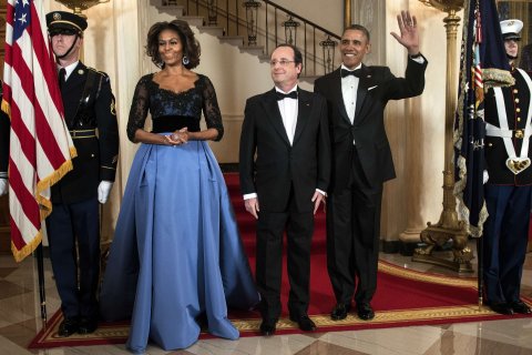 First Lady Michelle Obama, French President Francois Hollande and President Barack Obama pose in front of the Grand Staircase for an official photo before a State Dinner at the White House February 11, 2014 in Washington.