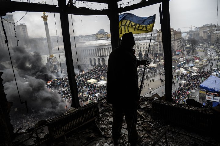 A demonstrator stands on a balcony overlooking Independence square in Kiev, February 20, 2014.