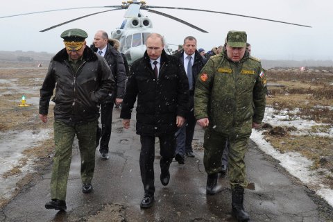 Russia's President Putin, accompanied by Russian Defence Minister Shoigu, walks to watch military exercises upon his arrival at Kirillovsky firing ground in Leningrad region